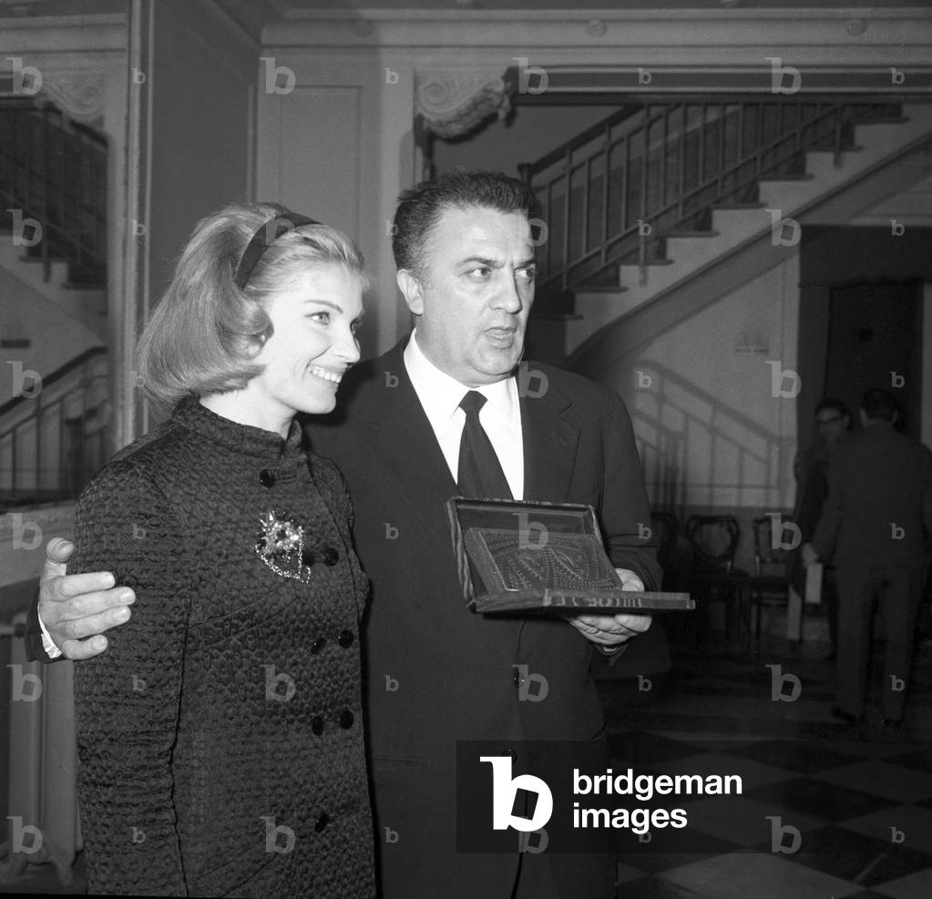 Federico Fellini and Gunnel Lindblom at a prize ceremony, Italy, 1957 (b/w photo)
