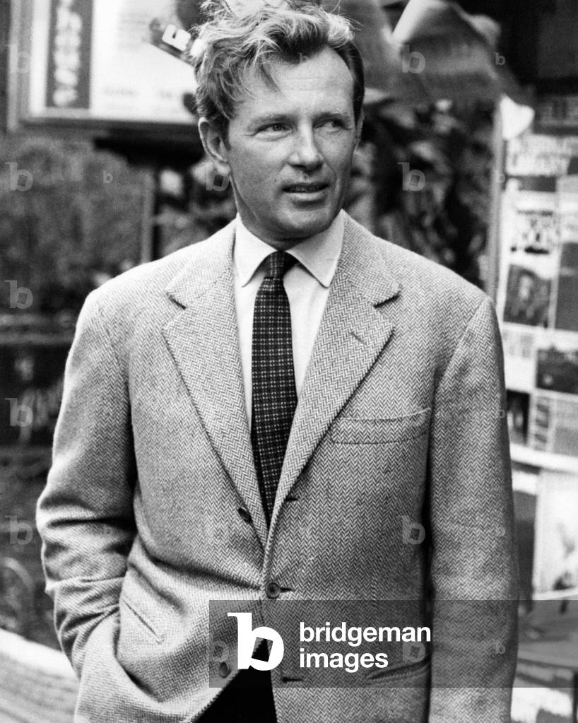 Jacques Sernas poses in the street
