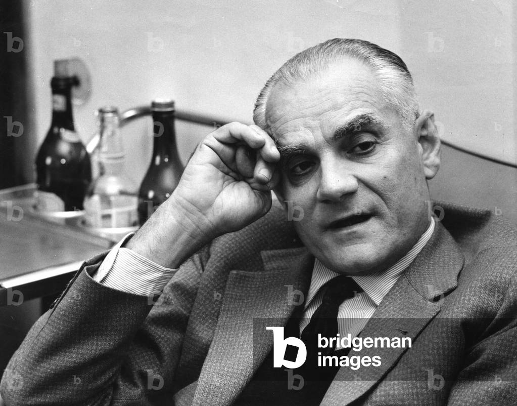Alberto Moravia sitting