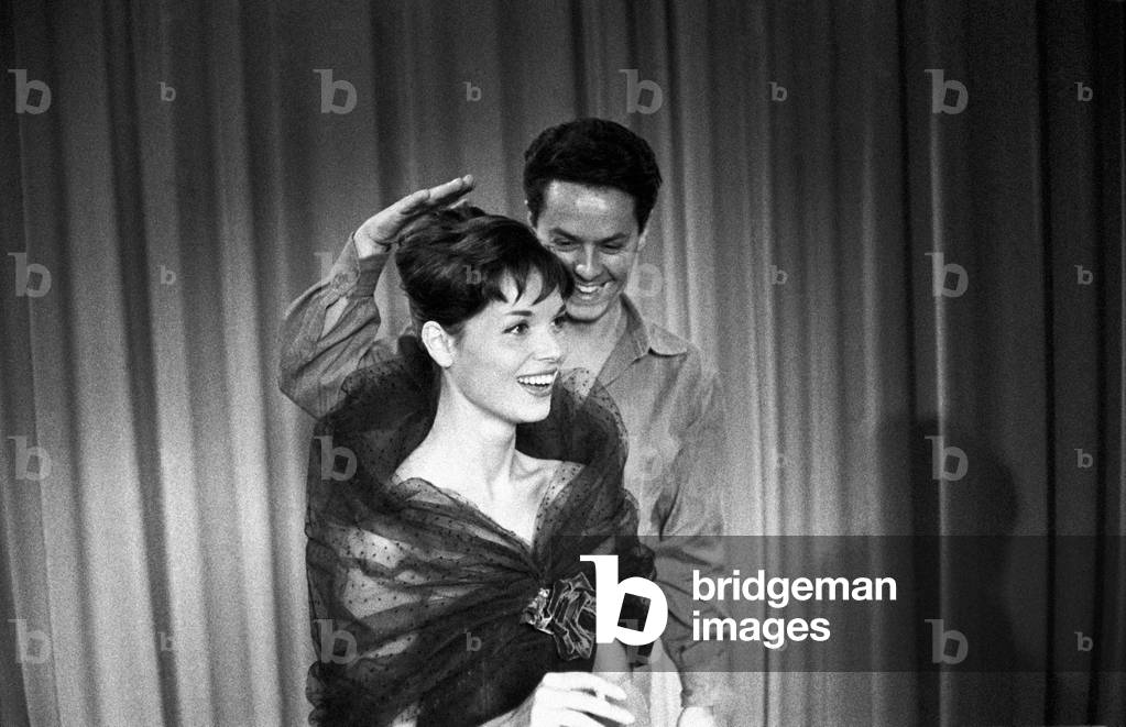 Roberto Capucci keeping his hand on the head of a model