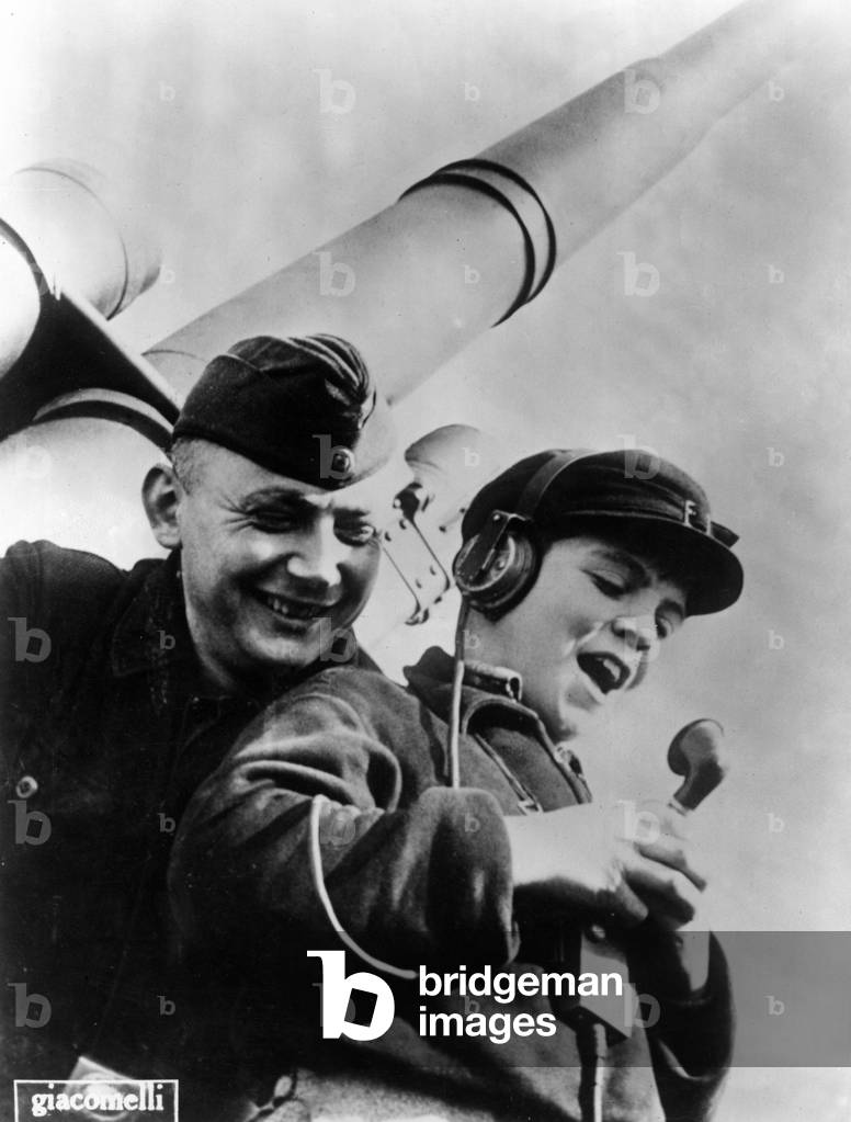 A boy from the Hitler Youth speaks into a microphone