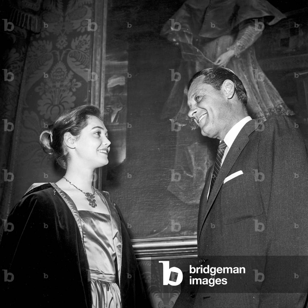 William Holden talking with a girl, Rome, Italy, 1957 (b/w photo)