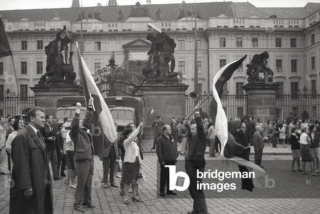 Prague citizens are waving the Czechoslovakian flag, 1968 (b/w photo)