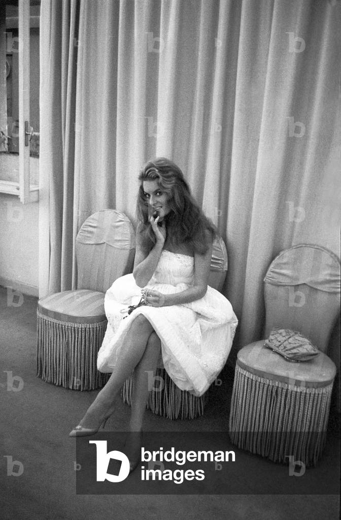 Belinda Lee sitting in Sorelle Fontana's workshop, Italy, 1956 (b/w photo)