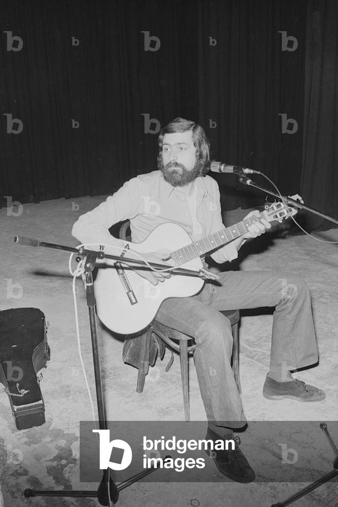 Francesco Guccini performing on stage at Teatro Quartiere in Quarto Oggiaro, Italy, 1976 (b/w photo)