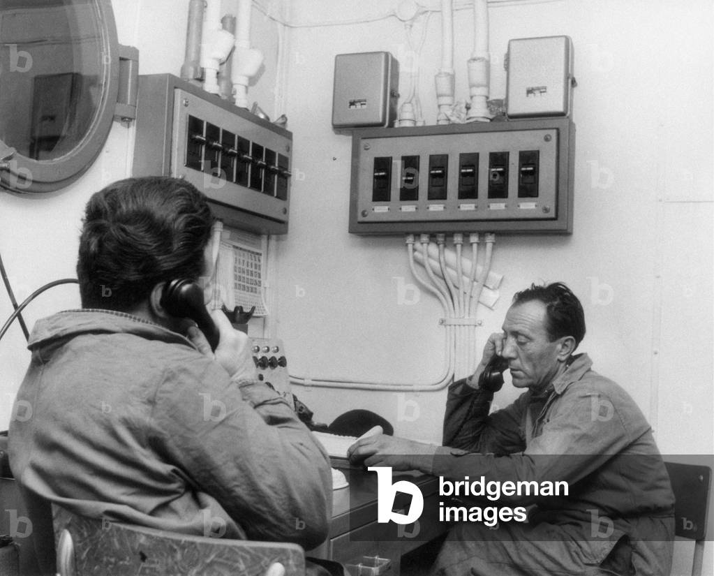 Workers at the phone on a SAROM oil platform, Ravenna, Italy