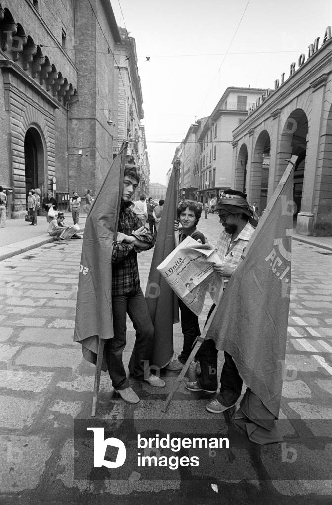 Three young men with the flags of their party