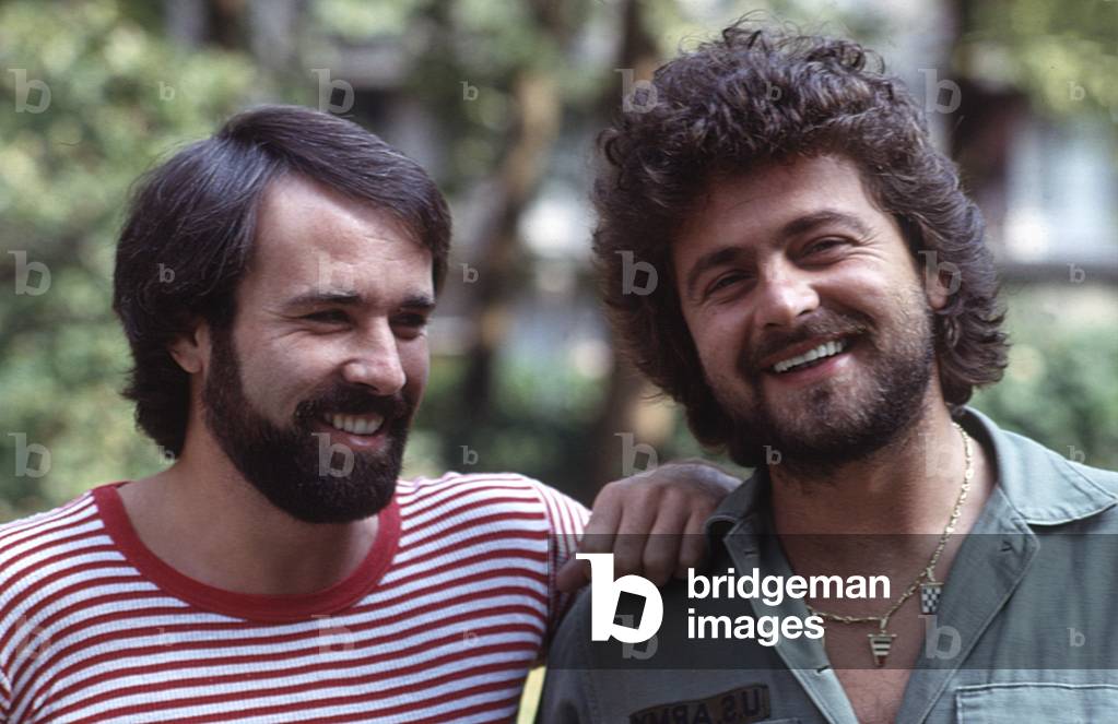 The comedian Beppe Grillo and the TV author Antonio Ricci smiling, 1979 (b/w photo)
