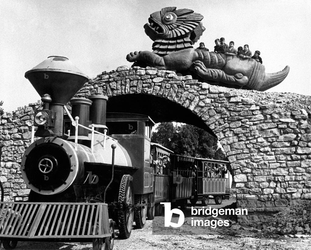 A train passing under a bridge surmounted by a dragon, Perugia, Italy