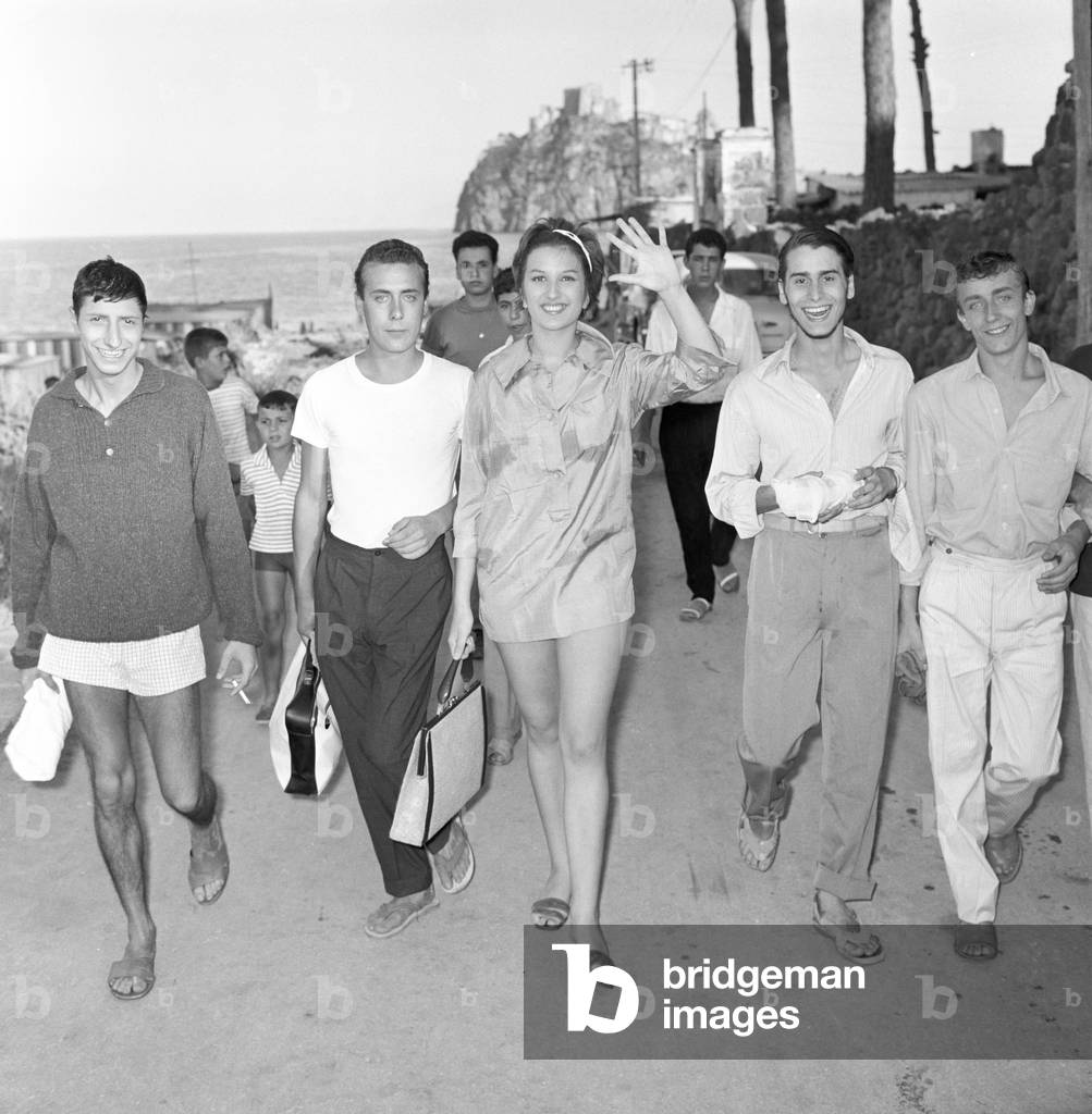 Mina and Pippo Franco on a boardwalk in Ischia, Italy, 1959 (b/w photo)