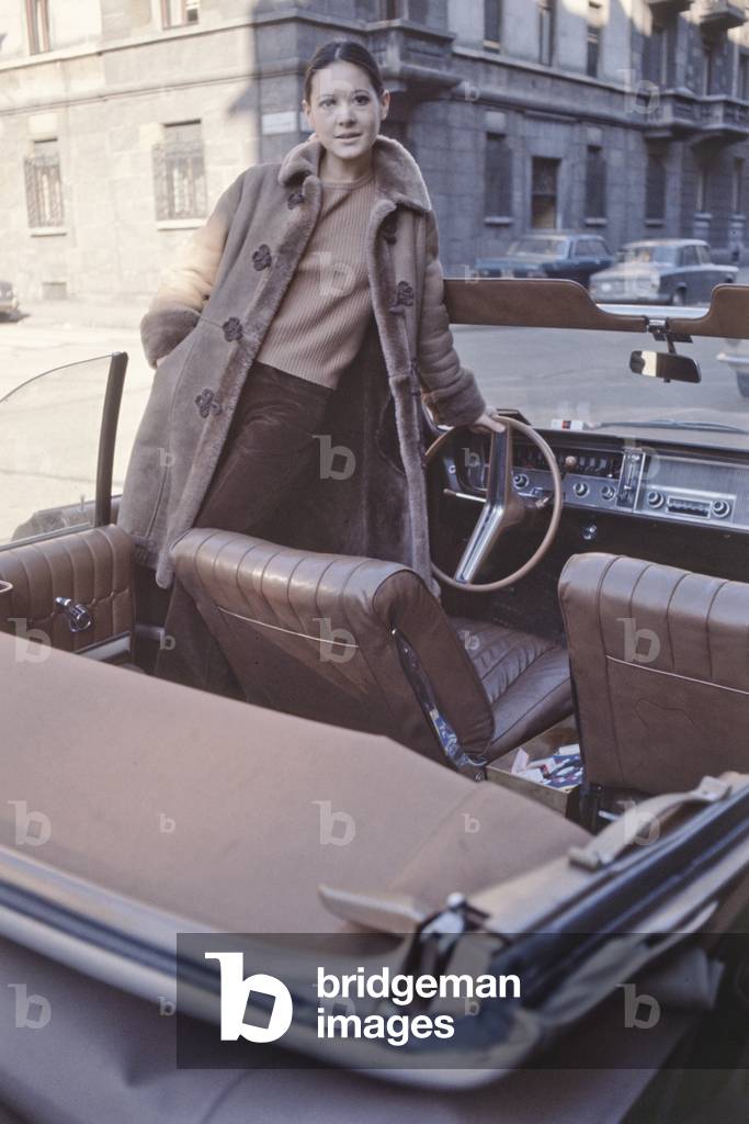 Anna Identici standing in a convertible car, Sanremo, Italy, 1968