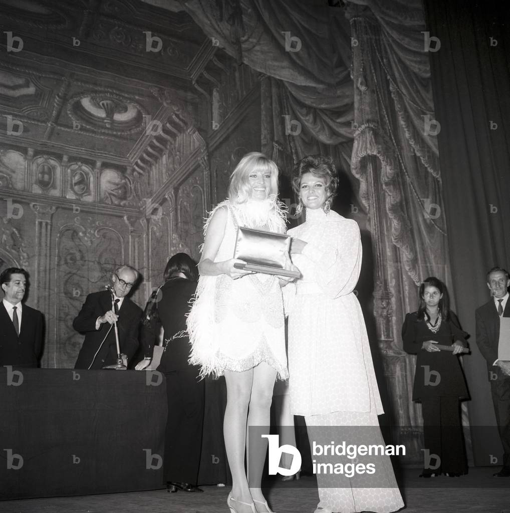 Monica Vitti and Claudia Cardinale during an awarding ceremony, Unspecified, 1961 (b/w photo)