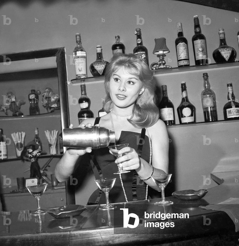 Marisa Allasio preparing a cocktail, Italy, 1957 (b/w photo)