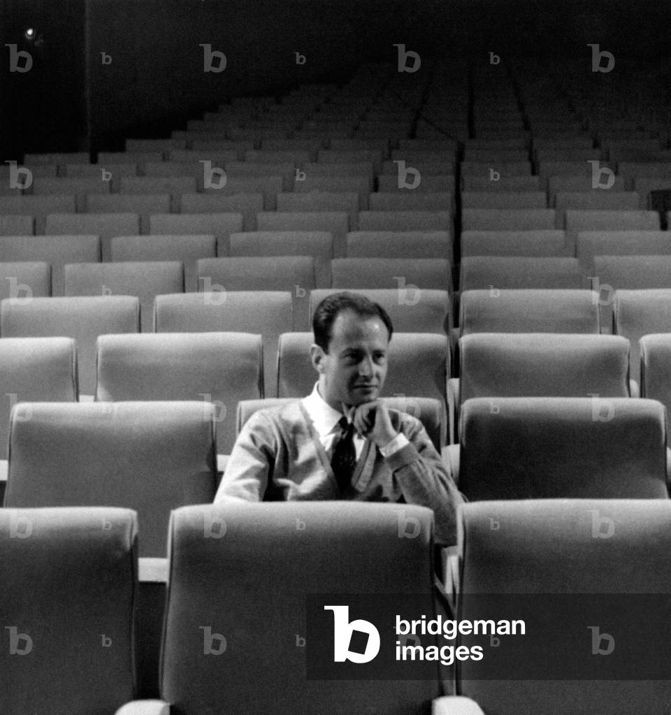 Portrait of Mario Ferrero thoughtful amongst the seats of a theatre