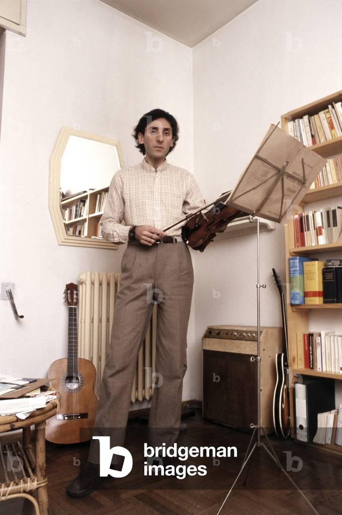 Franco Battiato holding a violin