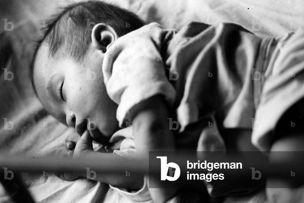 A Vietnamese baby sleeping, 1968 (b/w photo)