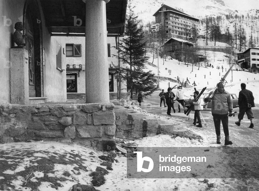 Skiers in front of the new church of Cervinia, Valtournenche, Italy