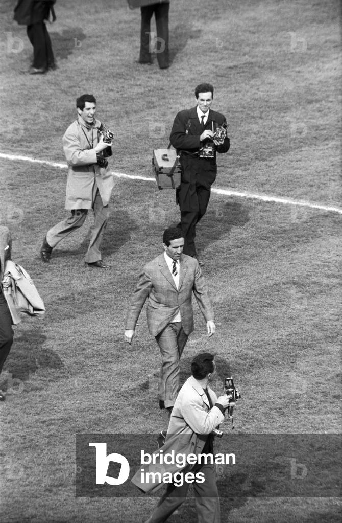 Helenio Herrera walking on a soccer field at the end of the soccer match, Bologna, Italy