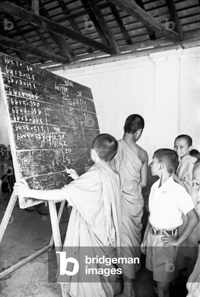 Young monks attending a maths class at a Buddhist monastery, Bangkok, 1961 (b/w photo)