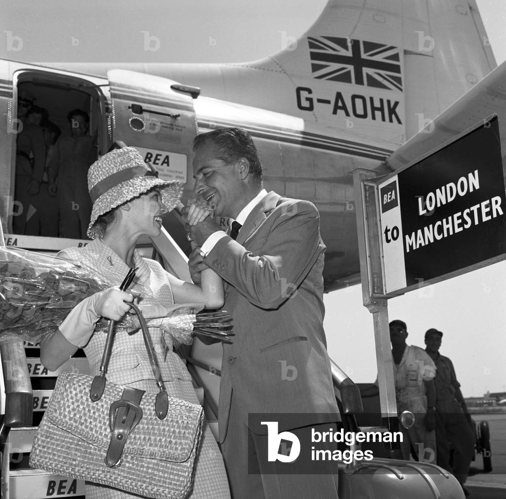 Rossano Brazzi and Leslie Caron at Ciampino airport, Italy, 1959 (b/w photo)