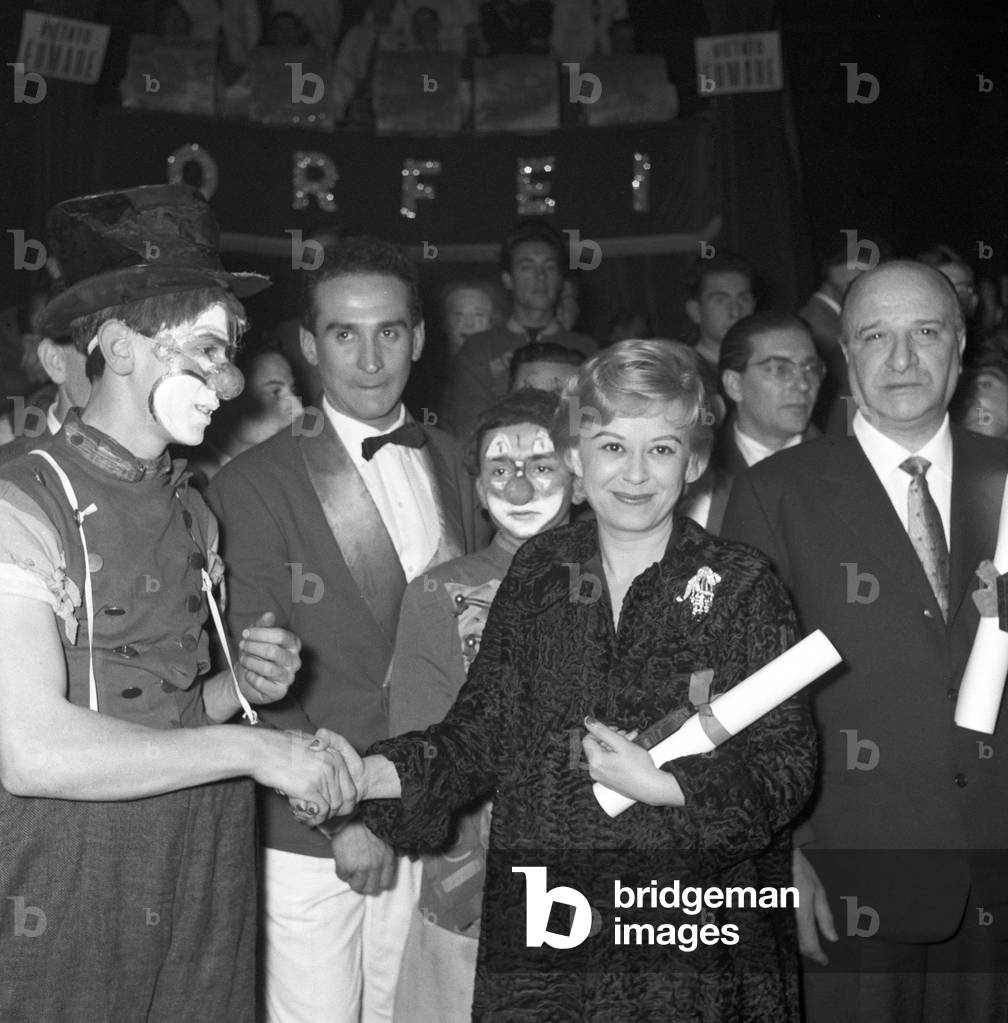 Giulietta Masina attending the Clown d'oro ceremony at the Orfei Circus, Italy, 1959 (b/w photo)