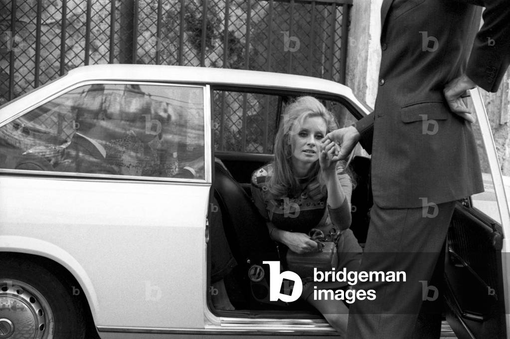 A woman getting out of a car, Italy