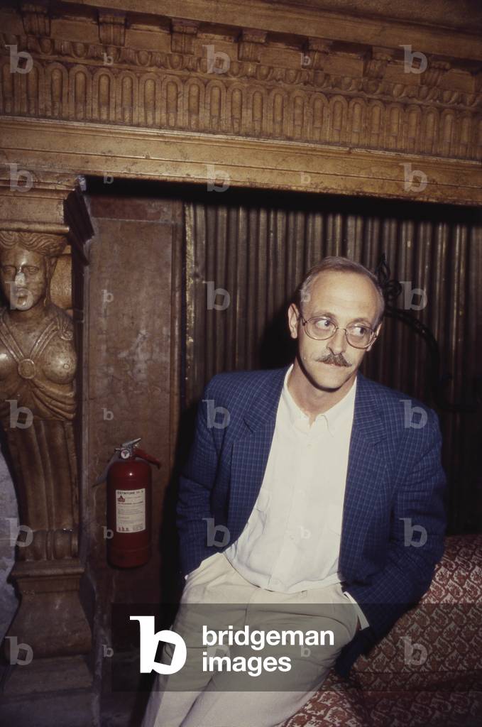 Antonio Tabucchi leaning on sofa