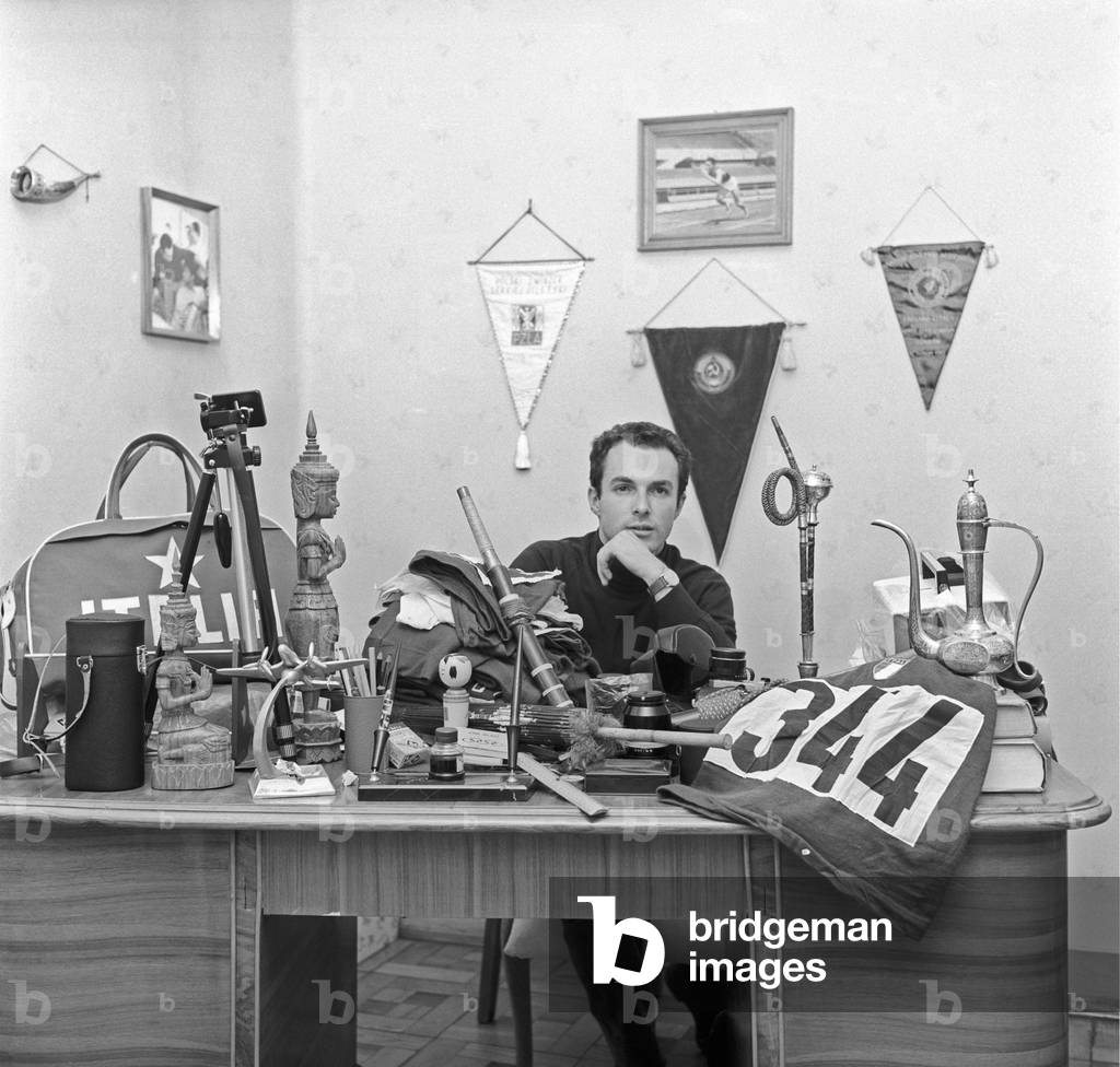 Livio Berruti posing between some souvenirs and trophies, Italy