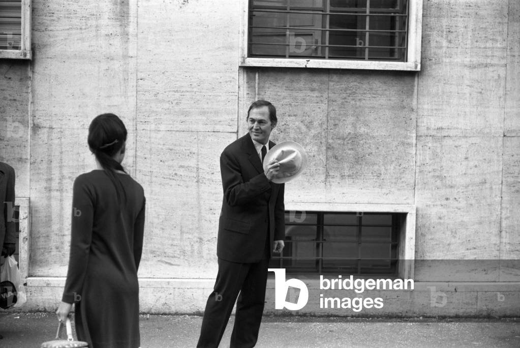 A man walking and greeting a woman, Italy