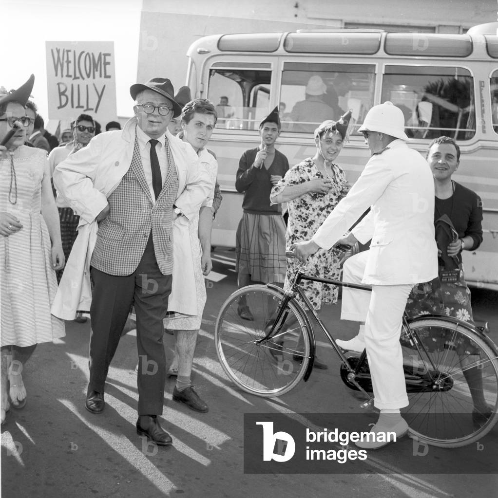 Some fans following Billy Wilder at the Ciampino Airport, Ciampino, Italy, 1959 (b/w photo)