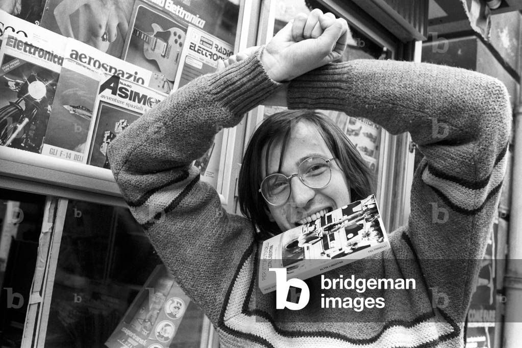Pier Vittorio Tondelli with a copy of Other libertini in his mouth