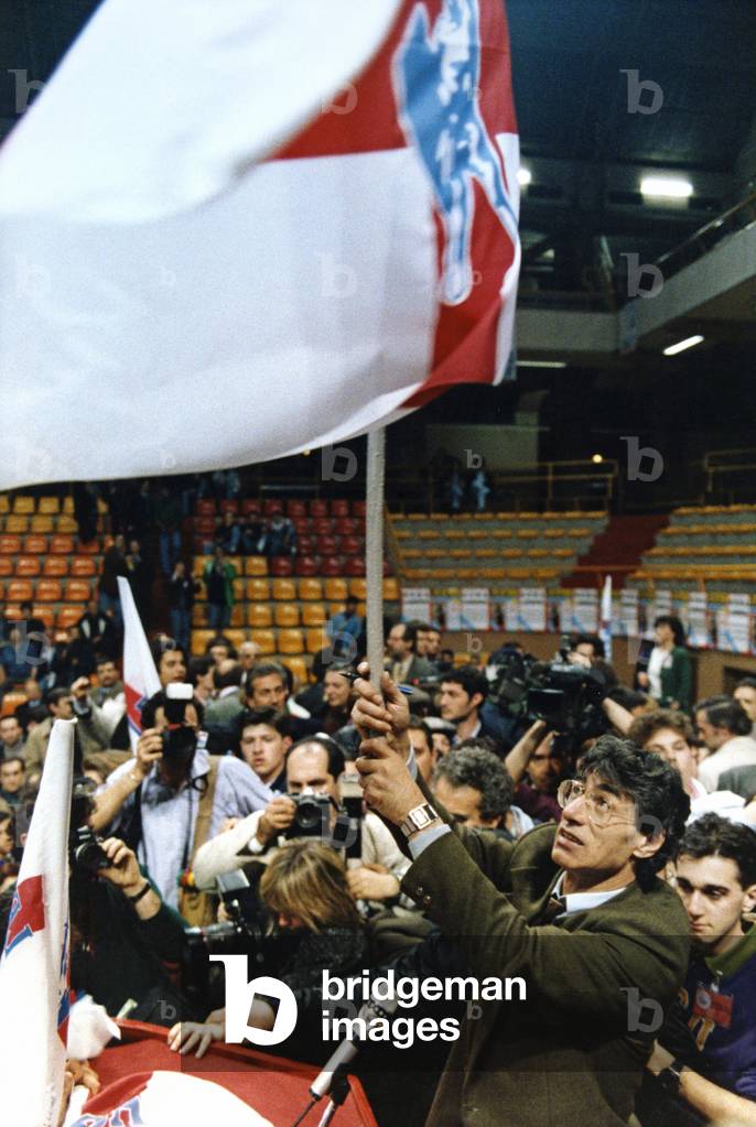 Umberto Bossi waving a flag