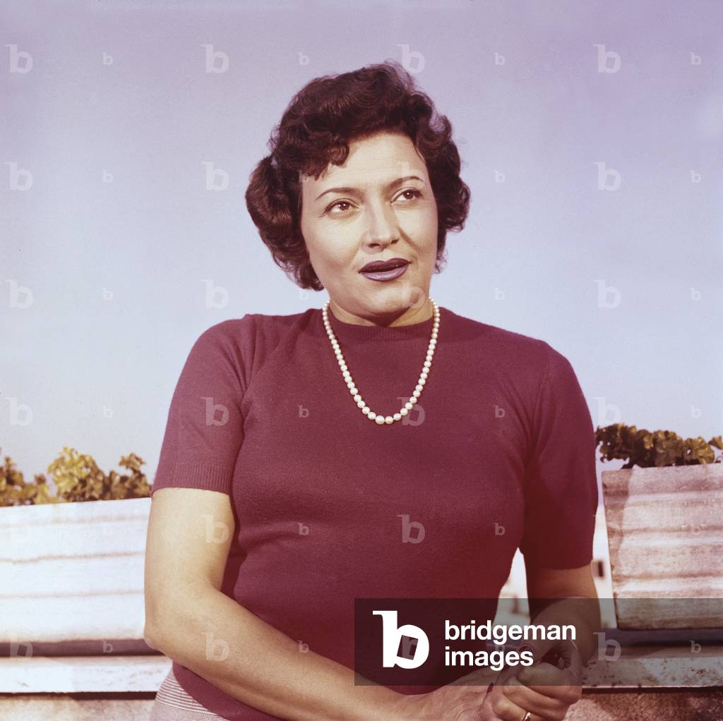 Portrait of Nilla Pizzi wearing a pearl necklace