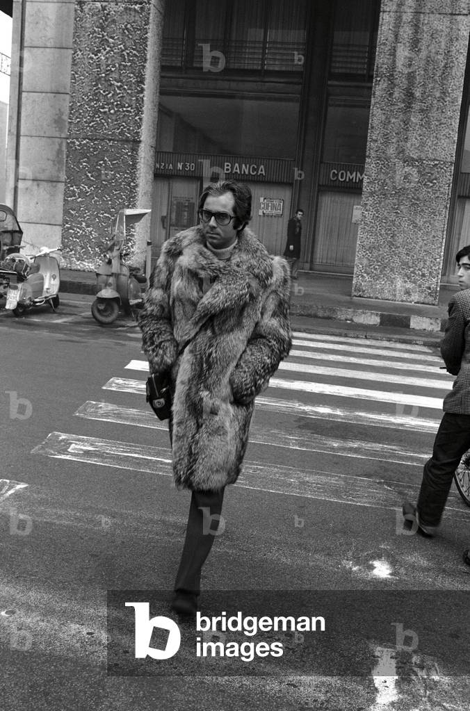 A man in a fur coat is walking