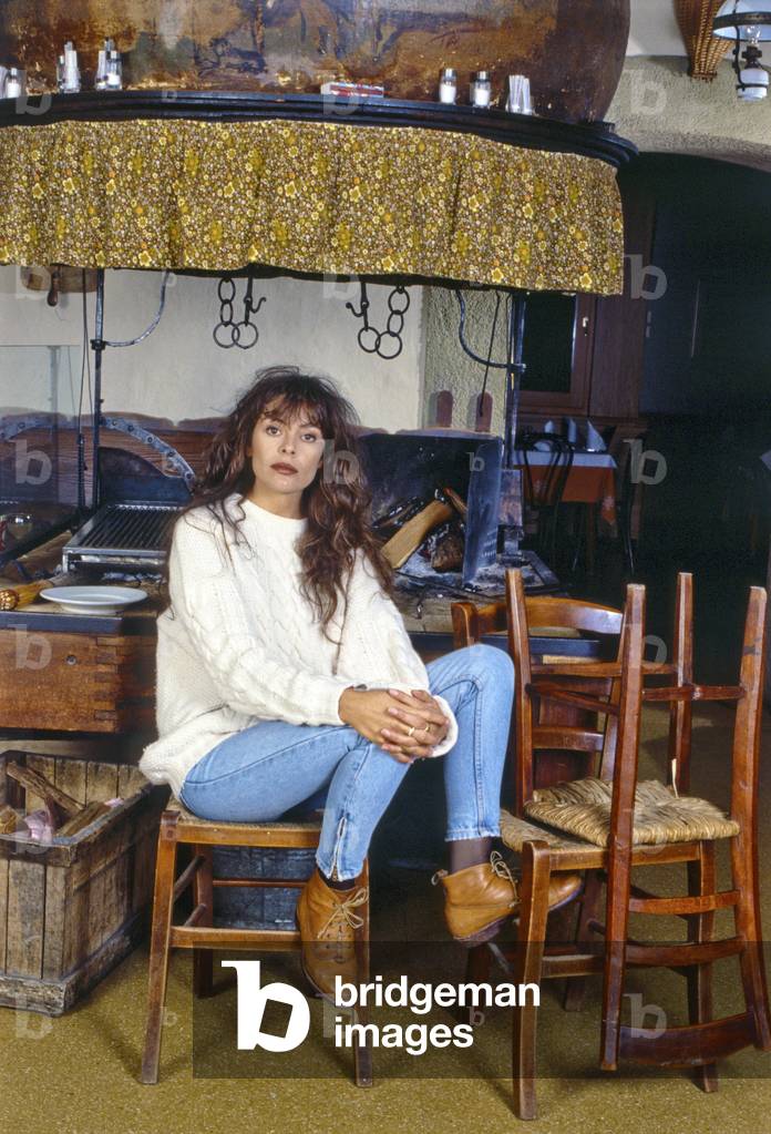 Alice seated on a chair