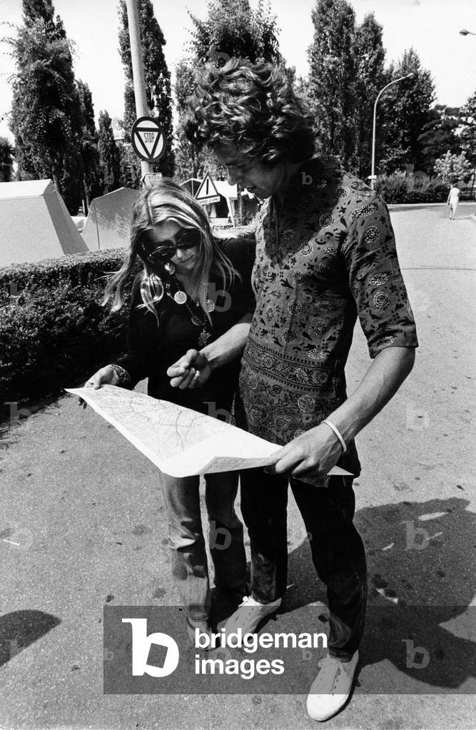 Two Tourists looking at the plan of Milan