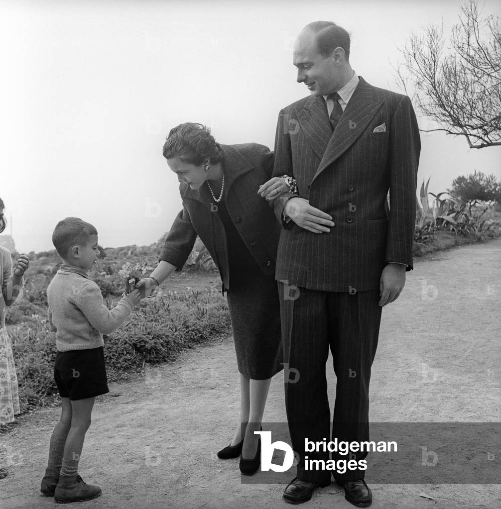 A child giving some flowers to Princess Maria Pia of Savoy and Prince Alexander of Yugoslavia, Cascais, Portugal