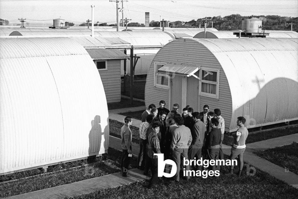 Some Italian immigrants gathering outside Fairy Meadows hostels, 15 kilometres far from the steel plant where they work, Wollongong, 1967 (b/w photo)