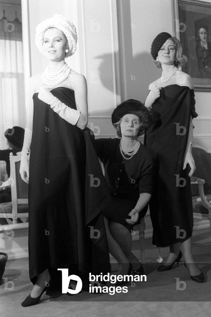 Biki sitting between two models