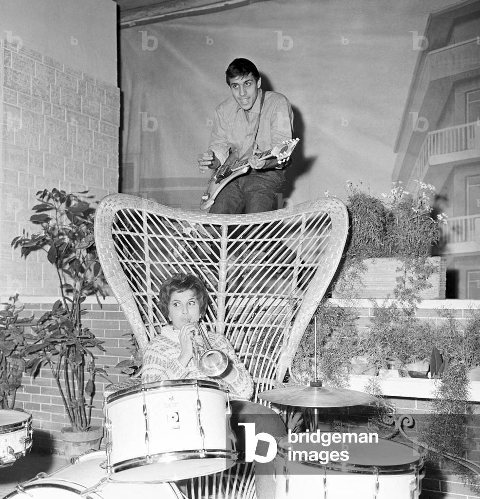 Mina and Adriano Celentano playing music, Italy, 1959 (b/w photo)