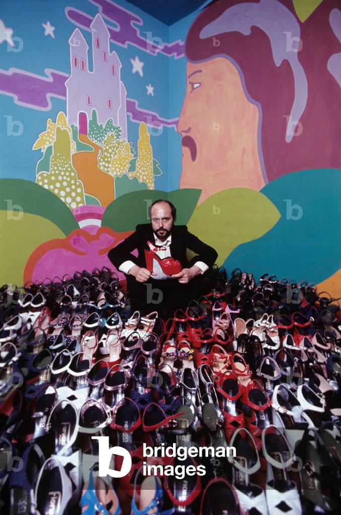 Elio Fiorucci posing near some shoes, Milan, Italy