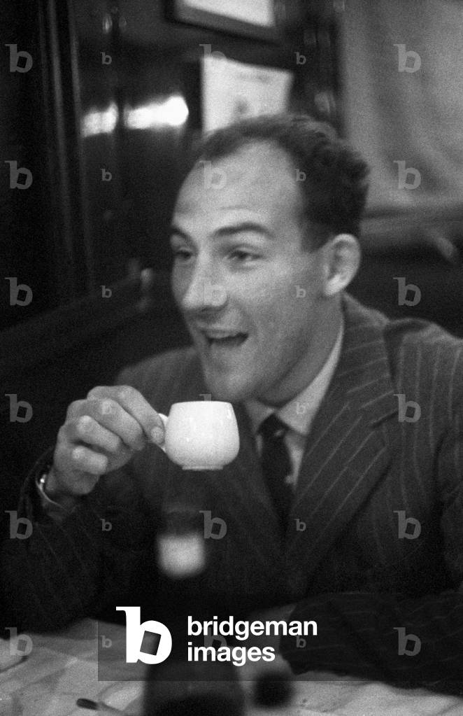 Stirling Moss holding a cup of coffee, Italy