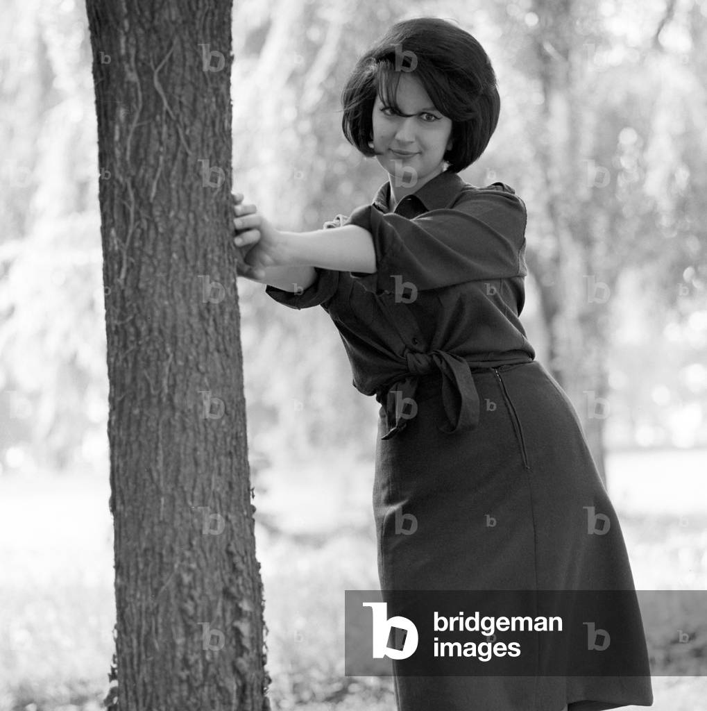 Mina leaning on a tree, Italy, 1963 (b/w photo)