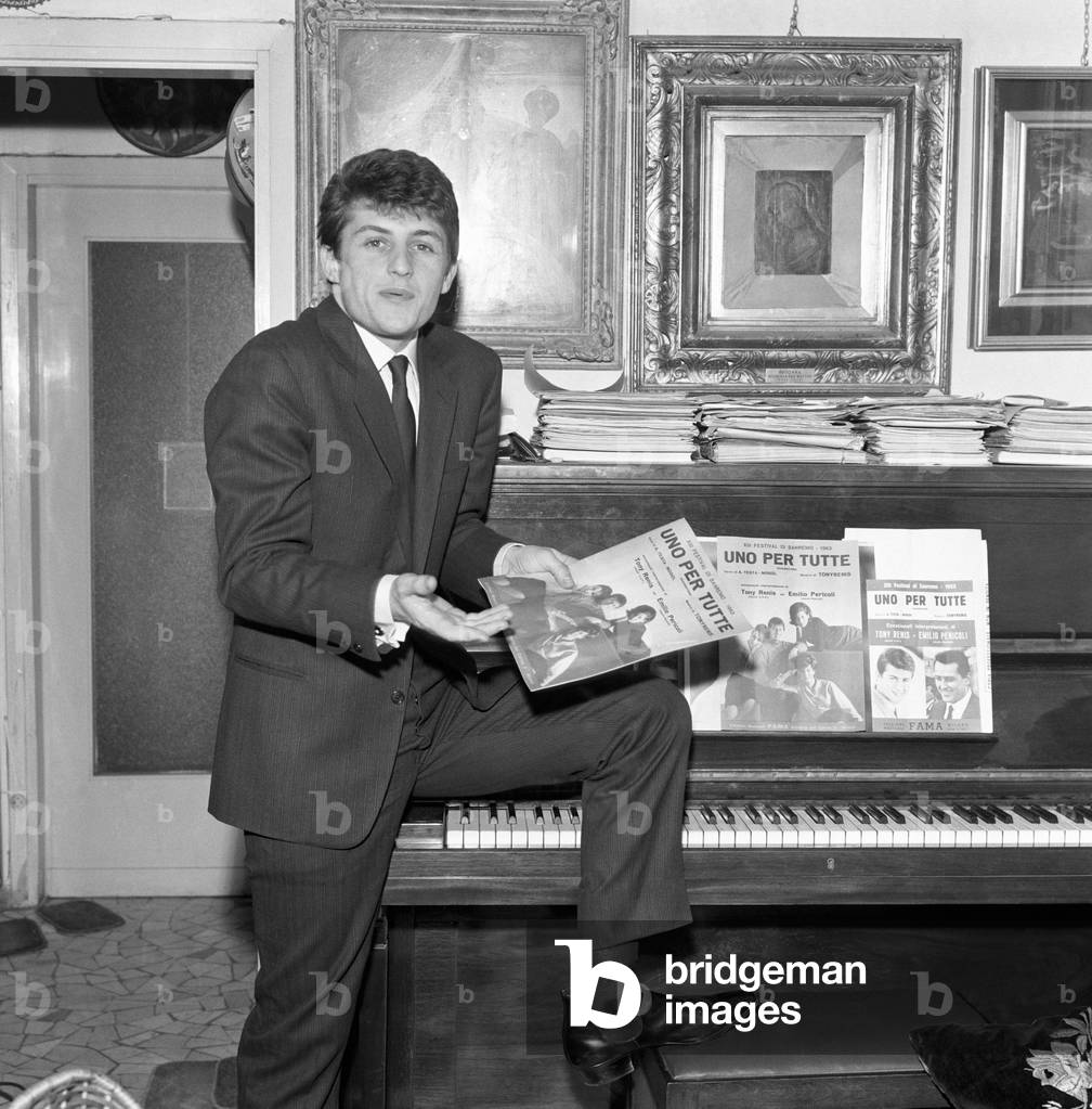 Tony Renis sitting on the piano