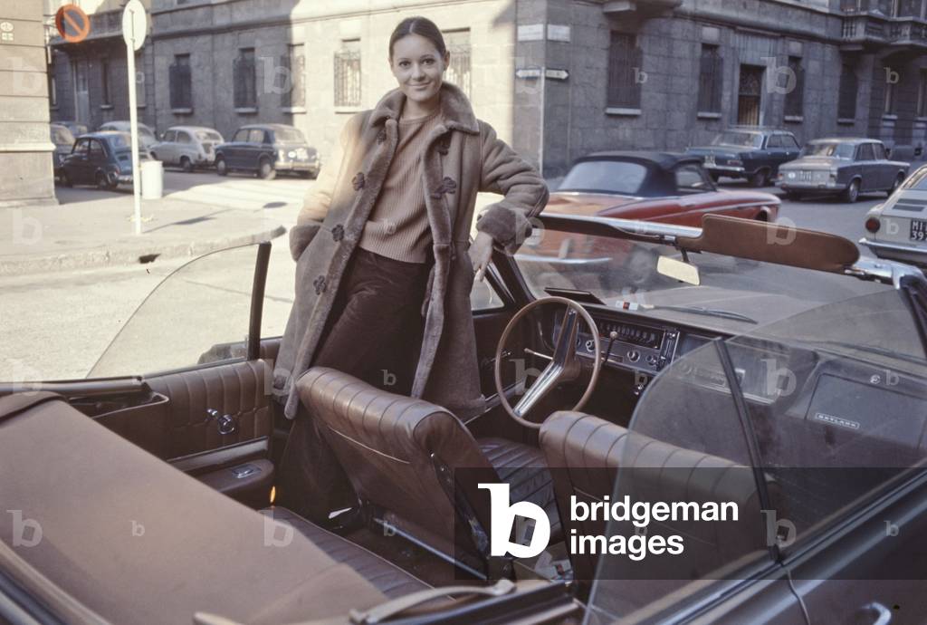 Anna Identici standing in a convertible car, Sanremo, Italy, 1968