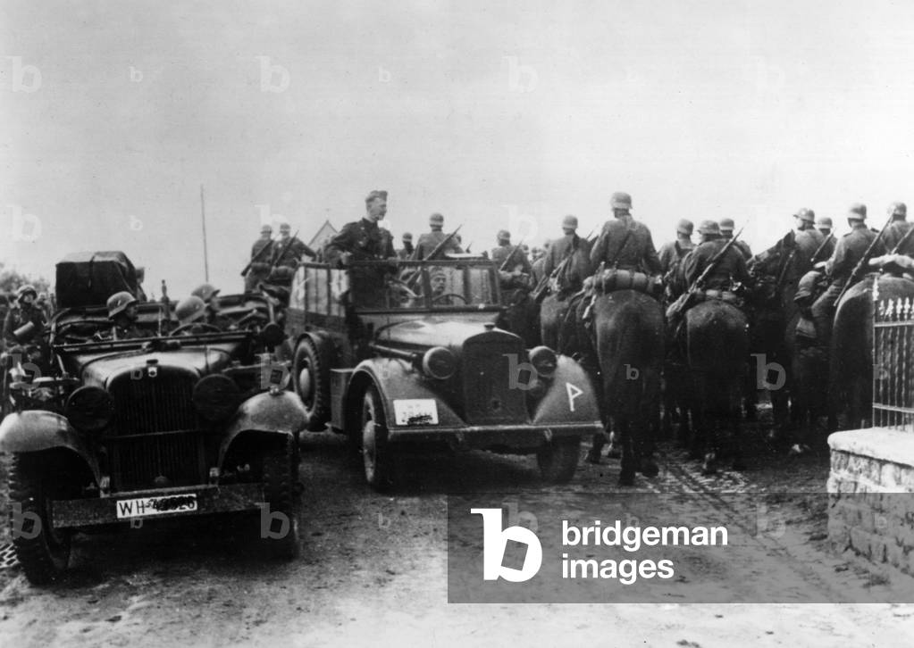 Military automobiles and a German cavalry squadron