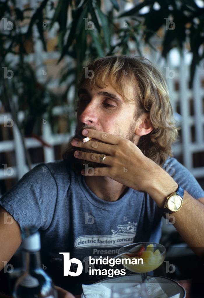 Mike Rutherford smoking a cigarette