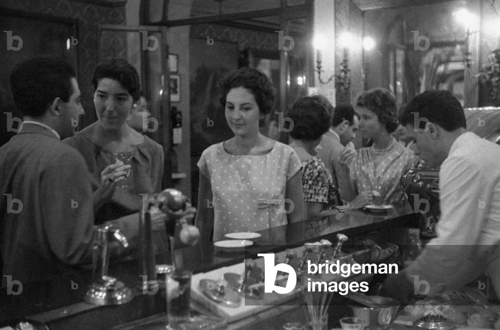 A girl standing at the bar of the Antico CaffèGreco, Rome, Italy