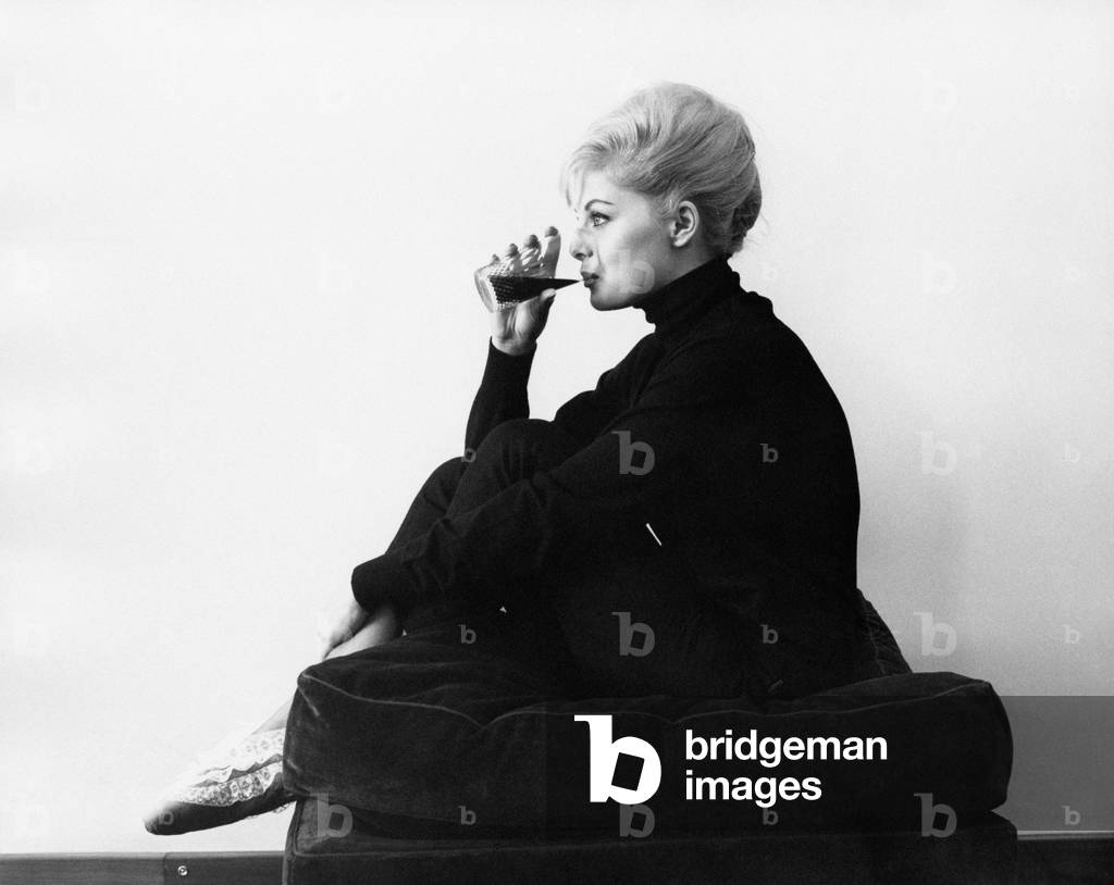 Virna Lisi on a pouf, 1961 (b/w photo)