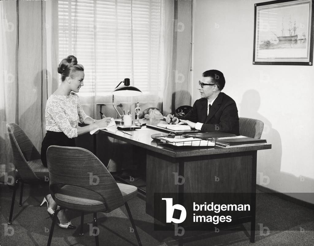 A secretary with her office supervisor, 1965 (b/w photo)